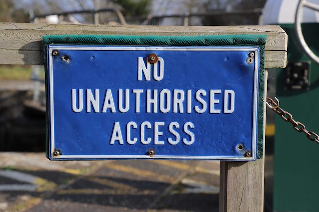 Metal sign with text 'No unauthorized access'