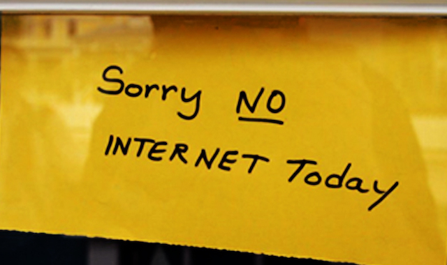 yellow piece of paper with handwritten words "Sorry NO INTERNET Today"