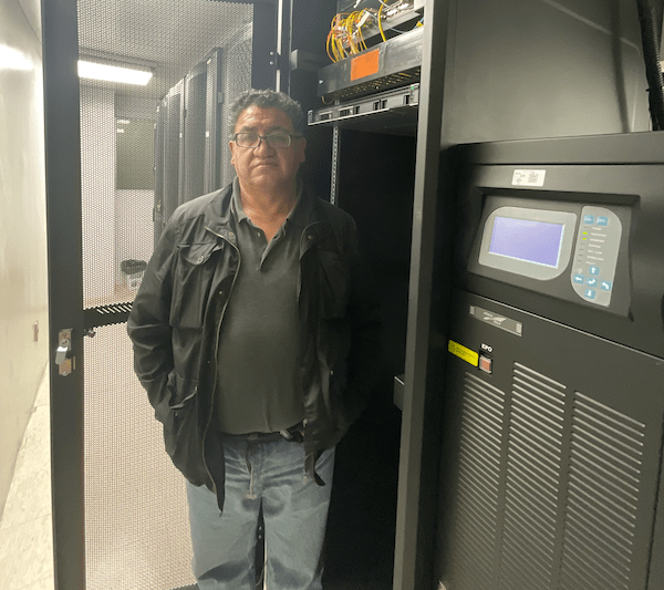 a man standing next to routing equipment